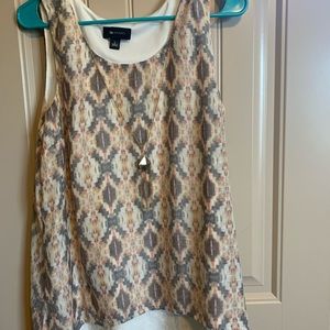 Woman’s sleeveless top with attached necklace .